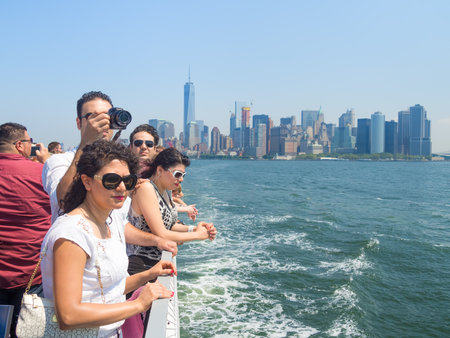 Tourists in a cruise ship on the bay of New York with the Manhattan skyline on the backgroundのeditorial素材