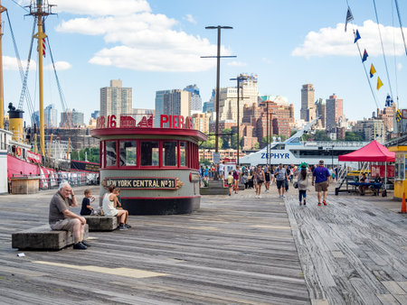 The South Street Seaport in downtown Manhattan with the Brooklyn skyline on the backgroundのeditorial素材