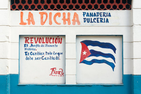 Revolutionary slogan and cuban flag painted on a wall in Havanaのeditorial素材