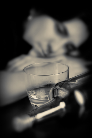 Monochrome image of a drunk woman with a sad expressionの写真素材