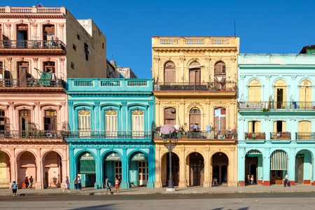 Street scene with old cars and colorful buildings in downtown Havanaの写真素材
