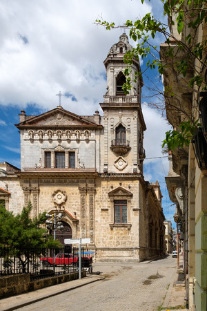 Old church and weathered buildings on a narrow street in Old Havanaの写真素材