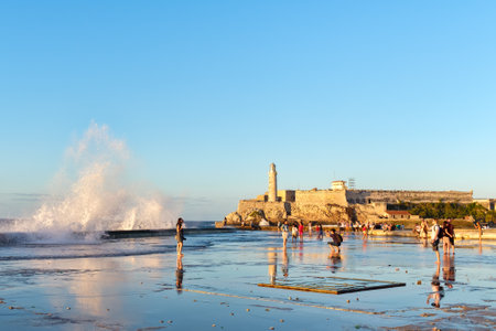 HAVANA,CUBA - JANUARY 24,2017 : El morro lighthouse in Havana with sea waves crashing on the Malecon seawallのeditorial素材