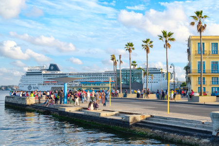 Street scene in Old Havana with colorful colonial buildings and a modern cruiser ship on the backgroundのeditorial素材