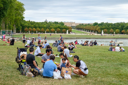Visitors camping at the gardens of the Palace of Versailles near Parisのeditorial素材