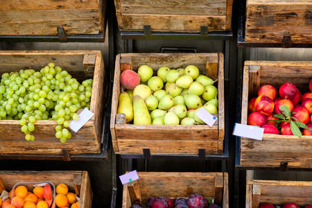 Fruits on rustic wooden boxes for sale on a street marketの写真素材