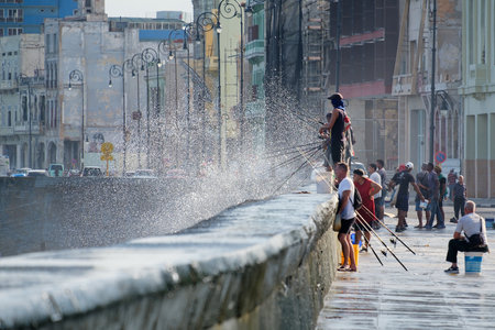 Fishermen at the famous Malecon seawall, a symbol of the city of Havanaのeditorial素材
