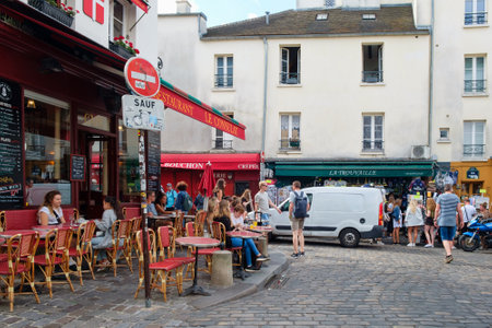 Street scene with traditional outdoor cafes in Montmartreのeditorial素材
