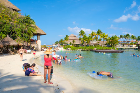 Families at the beach at XCaret Park on the Mayan Riviera on a beautiful sunny day in Mexicoのeditorial素材