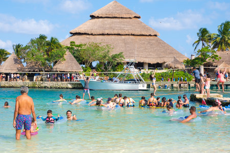 Families at the beach at XCaret Park on the Mayan Riviera on a beautiful sunny day in Mexicoのeditorial素材