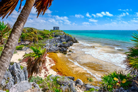 Mayan ruins on top of a cliff and a beautiful tropical beach at the Tulum archeological site in Mexicoのeditorial素材