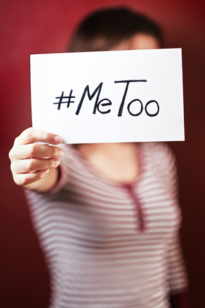 Young girl holding a sign supporting the #metoo campaignの写真素材