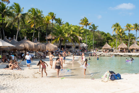 XCARET,MEXICO - APRIL 16,2019 : Families at the beach at XCaret Park on the Mayan Riviera on a beautiful sunny dayのeditorial素材