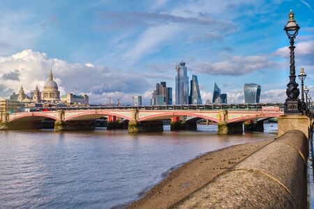 Blackfriars Bridge in London at sunset with a view of St Paul Cthedral and the City of Londonの写真素材