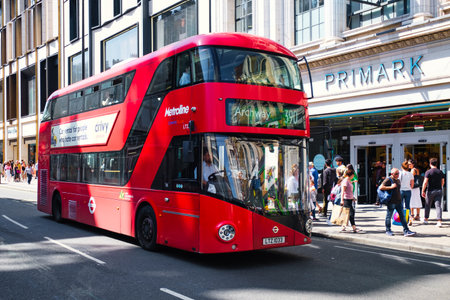 Typical red double decker bus next to the Primark store at Oxford Steet in Londonのeditorial素材