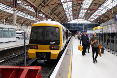 Passengers at the platform and trains at London Victoria Stationのeditorial素材