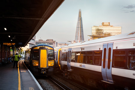 Trains at Waterloo station in London with The Shard skyscraper on the background