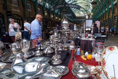 Stall selling antique silverware at the Apple Market at Covent Garden in Londonのeditorial素材