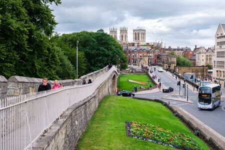 YORK, UNITED KINGDOM - AUGUST 11,2019 : The city walls with the Cathedral on the background at the medieval city of York in Englandの写真素材