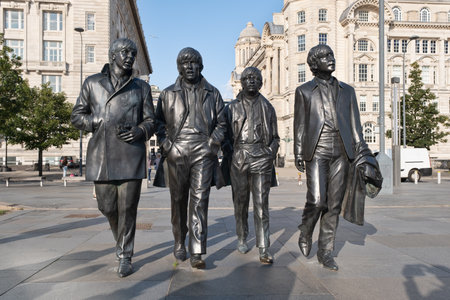 Iconic bronze statues of the four Beatles in front of the Mersey waterfront in Liverpoolのeditorial素材