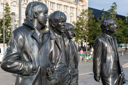 Iconic bronze statues of the four Beatles in front of the Mersey waterfront in Liverpoolのeditorial素材