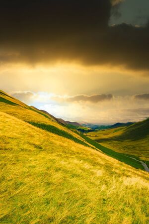 Sunset at a valley among the mountains of the famous Lake District in Englandの写真素材