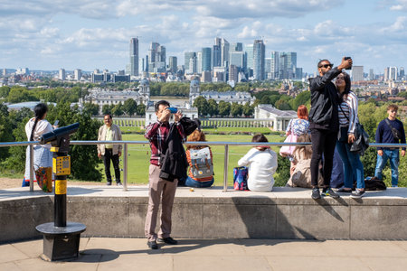 LONDON,UK - AUGUST20,2019 : Visitors at the Royal Observatory in Greenwich with a view of Greenwich Park and Canary Wharfのeditorial素材