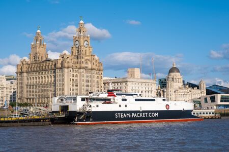 Cruiser ship docked at the Port of Liverpool with a view of the famous Three Graces buildingsの写真素材