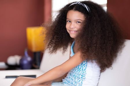 Portrait of a cute multiracial small girl with beautiful curly hairの写真素材