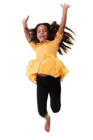 Happy multiracial small girl jumping in the air and laughing - Isolated on whiteの写真素材