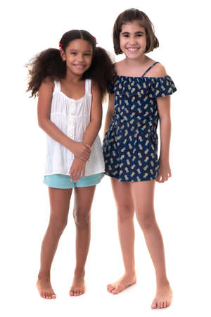 Two friendly small girls, friends or sisters  - Hispanic and african-american - Isolated on whiteの写真素材