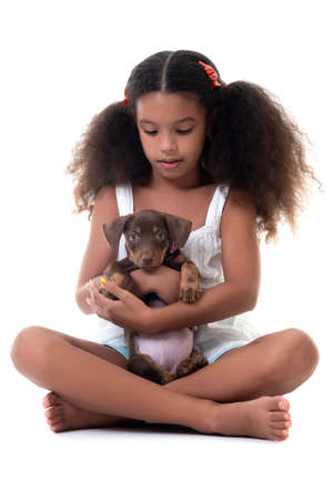 Adorable multiracial girl holding a small stray dog - Isolated on a white backgroundの写真素材
