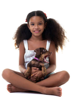 Adorable multiracial girl holding a small stray dog - Isolated on a white backgroundの写真素材
