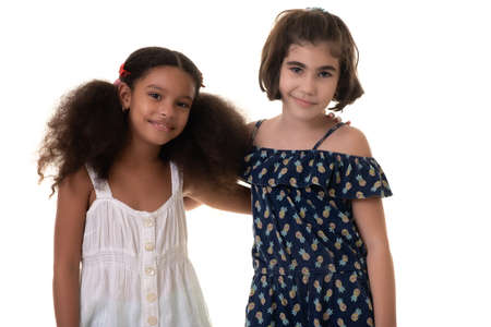 Two friendly small girls, friends or sisters  - Hispanic and african-american - Isolated on whiteの写真素材