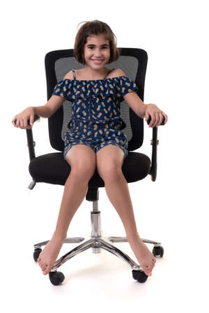 Cute hispanic girl sitting on an office chair - Isolated on a white backgroundの写真素材