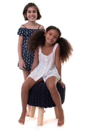 Two friendly small girls, friends or sisters  - Hispanic and african-american - Isolated on whiteの写真素材