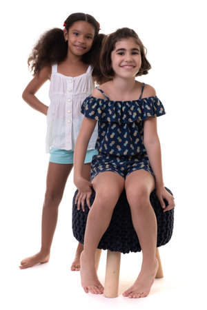 Two friendly small girls, friends or sisters  - Hispanic and african-american - Isolated on whiteの写真素材