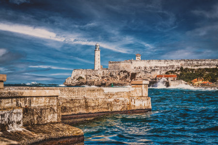 The fortress and lighthouse of El Morro and the Malecon seawall, symbols of the city of Havana in Cubaのeditorial素材