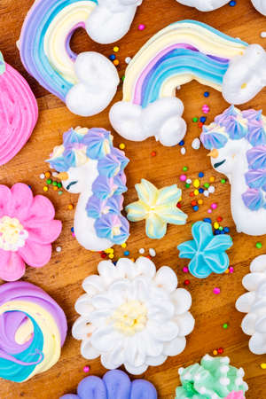 Collection of colorful meringues on a wooden backgroundの写真素材