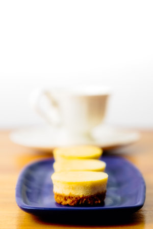 Small round homemade cheesecakes served with tea for a snackの写真素材