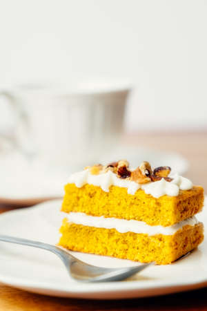 Homemade carrot cake served with a cup of tea