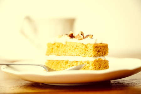 Homemade carrot cake served with a cup of teaの写真素材
