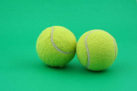 two tennis balls on greenの写真素材