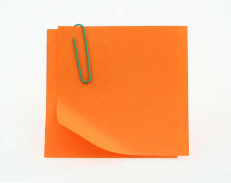 orange post-it notes with a bent corner on whiteの写真素材