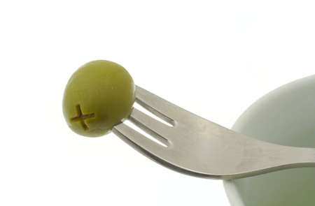 olive stuck on a forkの写真素材