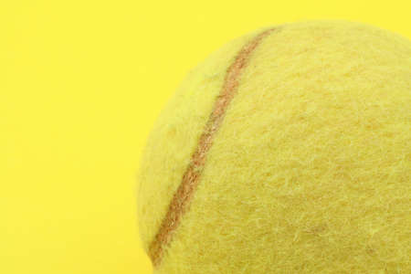 tennis ball profile on yellowの写真素材
