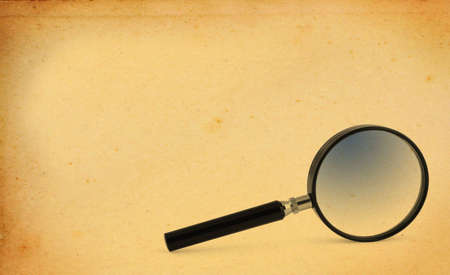 magnifying glass with yellowed paper copy spaceの写真素材
