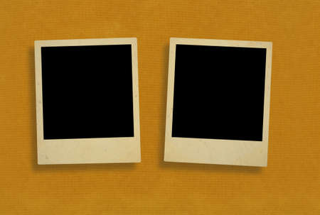 two old photo frames against rough paperの写真素材