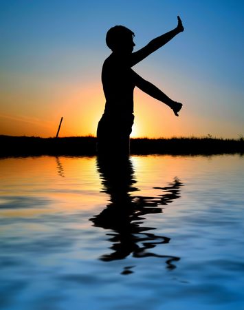 sunset silhouette doing excercisesの写真素材