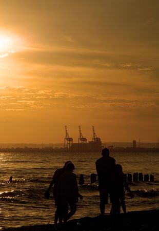  sunset stroll against, large port cranes in background の写真素材